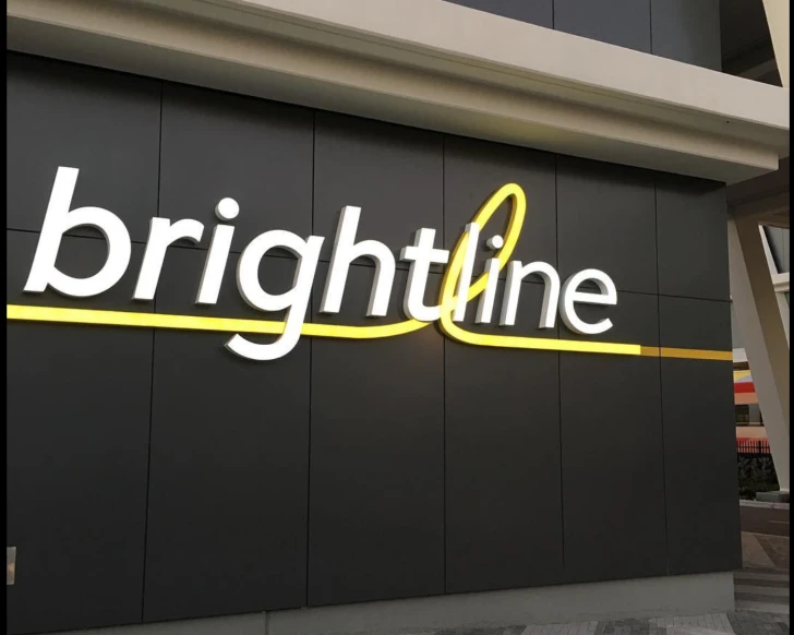 Decorative Brightline sign in white and yellow.