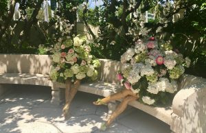 Opulent bouquets of flowers placed on a concrete garden beach.